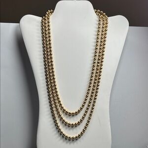 Infinity metal gold tone bead necklace